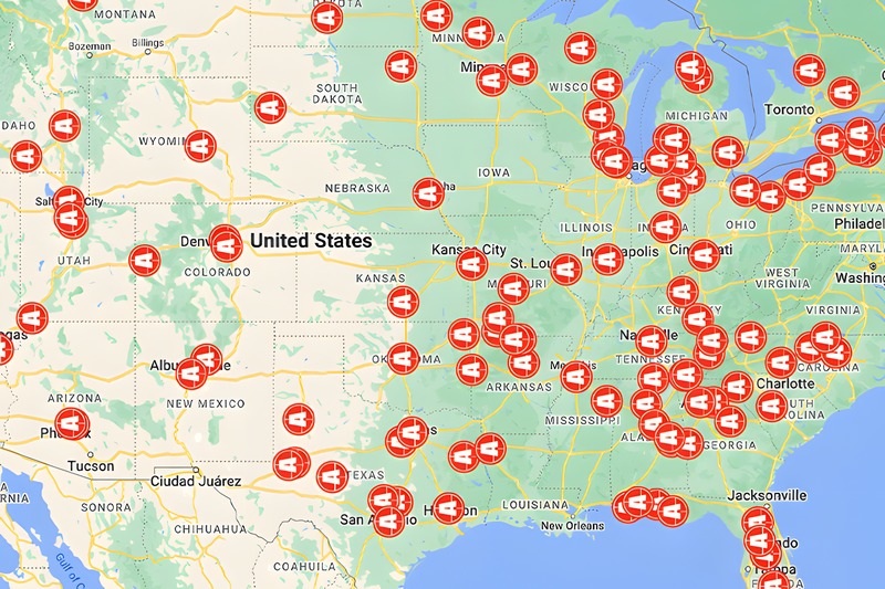 A map of the United States dotted with red Axis dealer location pins from coast to coast.