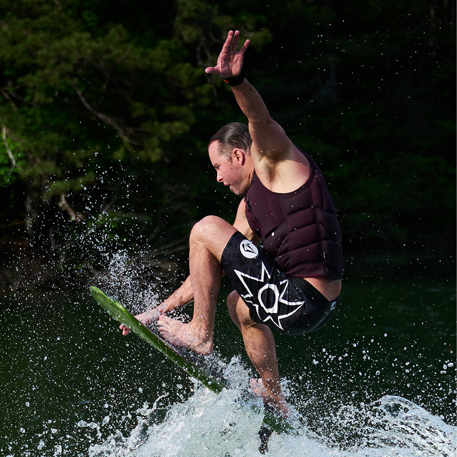 Profile shot of Johnny hitting a big wave