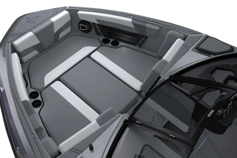 Studio render of the gray-and-white captain's helm seat in an Axis T220, flip-up bolster beside the Axis-logo steering wheel and dash, on a white background.