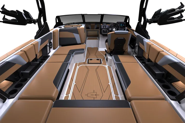 Wide studio render of the full tan-and-white cockpit of an Axis T235 wake boat, wraparound seating, helm and tower speakers viewed from the rear on a white background.